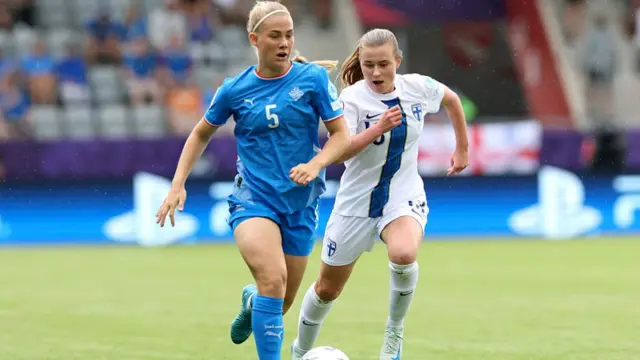 Saedis Run Heidarsdottir of Iceland runs with the ball under pressure from Oona Siren of Finland during the UEFA Women's EURO 2025 Group A match between Iceland and Finland at Arena Thun on July 02