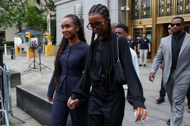Daughters of Sean Combs walk outside court holding hands