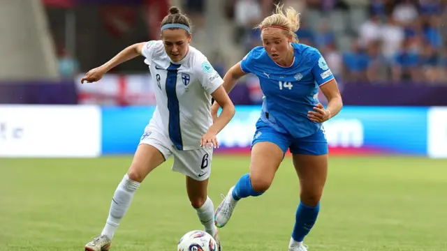 Joanna Tynnila of Finland runs with the ball under pressure from Hlin Eiriksdottir of Iceland during the UEFA Women's EURO 2025 Group A match between Iceland and Finland at Arena Thun