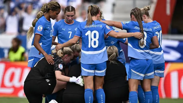 Iceland's forward #23 Sveindis Jane Jonsdottir, Iceland's midfielder #07 Karolina Lea Vilhjalmsdottir and teammates looks at Iceland's defender #04 Glodis Viggosdottir receiving treatment during the UEFA Women's Euro 2025 Group A football match between Iceland and Finland at the Arena Thun stadium