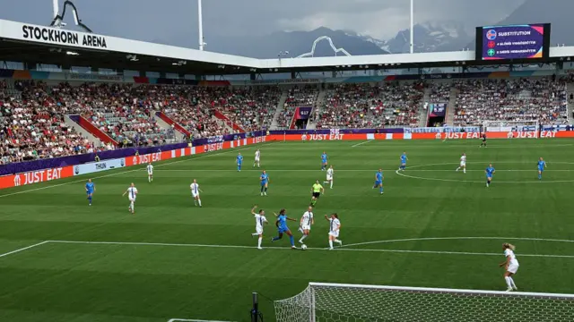 General view inside the stadium, as Sveindis Jane Jonsdottir of Iceland runs with the ball under pressure from Natalia Kuikka, Eveliina Summanen and Oona Siren of Finland during the UEFA Women's EURO 2025 Group A match between Iceland and Finland at Arena Thun