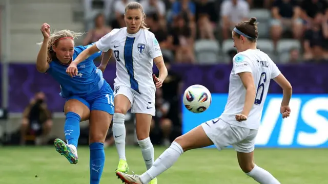 Hlin Eiriksdottir of Iceland passes the ball under pressure from Katariina Kosola and Joanna Tynnila of Finland during the UEFA Women's EURO 2025 Group A match between Iceland and Finland at Arena Thun