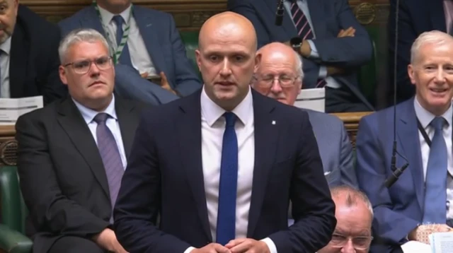 Stephen Flynn stands and speaks in the House of Commons