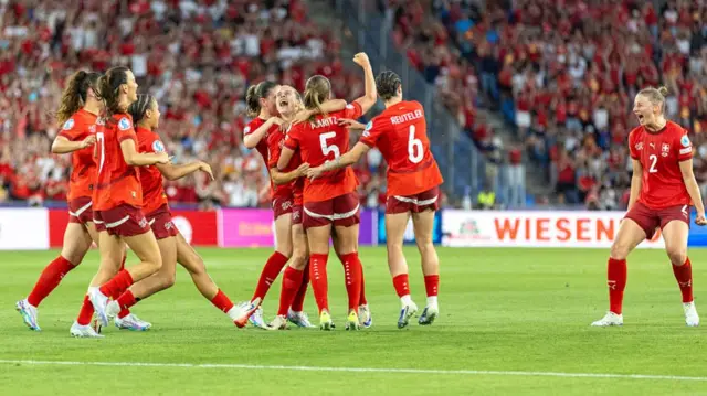 Nadine Riesen of Switzerland (R) celebrates with teammates after scoring her team's first goal during the UEFA Women's EURO 2025 Group A match between Switzerland and Norway at St. Jakob-Park on July 2, 2025 in Basel, Switzerland.