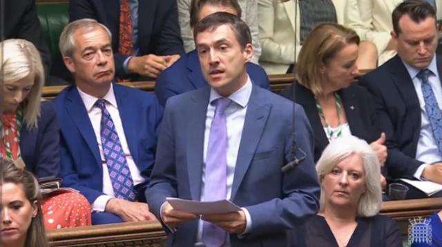 Adrian Ramsey stands in the House of Commons, speaking