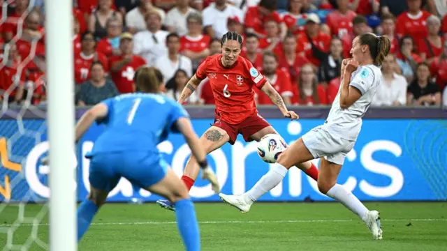 Switzerland's forward #06 Geraldine Reuteler (C) eyes the ball during the UEFA Women's Euro 2025 Group A football match between Switzerland and Norway at the St Jakob-Park Stadium in Basel on July 2, 2025.