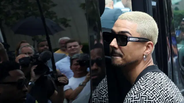 Quincy Brown, son of Sean "Diddy" Combs as he enters a black van
