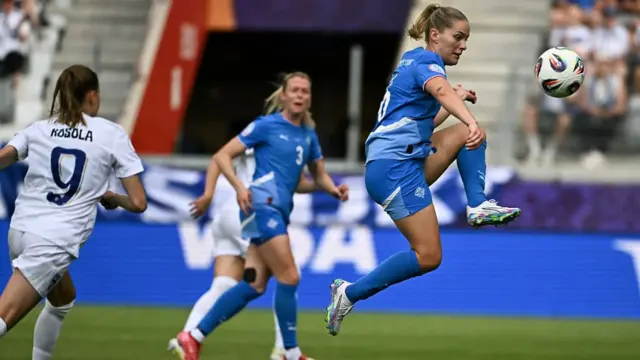 Iceland's midfielder #16 Hildur Antonsdottir (R) next to Finland's midfielder #09 Katariina Kosola (L) jumps for the ball during the UEFA Women's Euro 2025 Group A football match between Iceland and Finland at the Arena Thun stadium