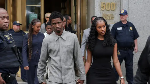 King Combs and Raven Tracy walk outside the U.S. federal court