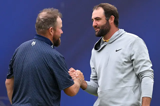 Shane Lowry shakes hands with Scottie Scheffler