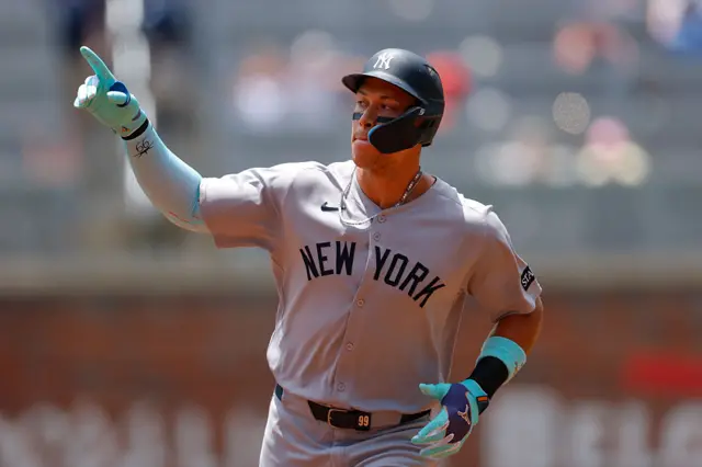 Aaron Judge #99 of the New York Yankees reacts after hitting a solo home run