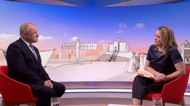 Ed Davey (L) listens to Laura Kueensberg (R) asking him questions inside the tv studio
