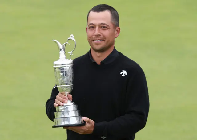 Xander Schauffele holds the Claret Jug in 2024