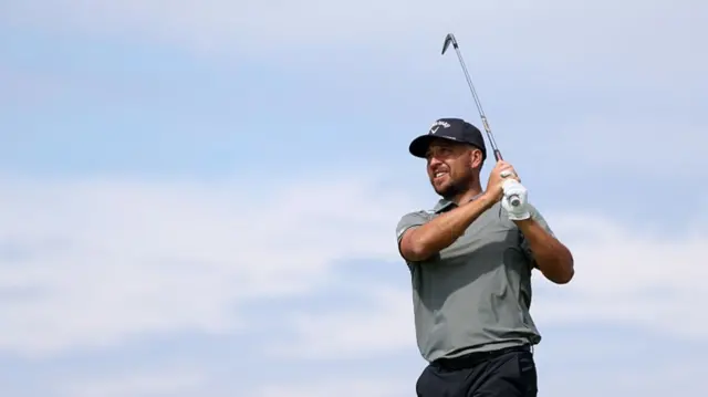 Xander Schauffele framed against a blue sky