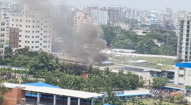 A photo of a building with plumes of smoke rising from it