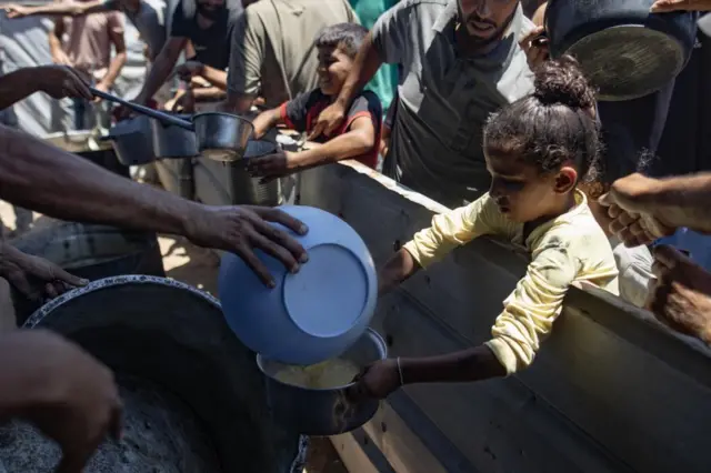 People receiving food rations at a charity kitchen in Gaza City on Saturday