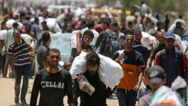Palestinians collect aid supplies from the U.S.-backed Gaza Humanitarian Foundation, in Rafah, in the southern Gaza Strip, June 9, 2025.