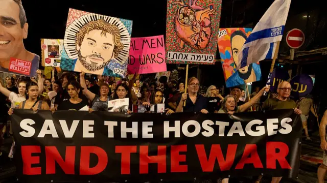 Families of hostages and supporters hold signs and photos of hostages held in the Gaza Strip during a march calling for a deal that will release all hostages on July 19, 2025 in Tel Aviv, Israel.