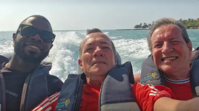 Yostin Mosquera (left) Albert Alfonso (middle) and Paul Longworth (right). They are all on a speedboat smiling into camera.