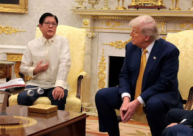 Philippines President Ferdinand Marcos Jr. speaks in the Oval Office as Trump watches on