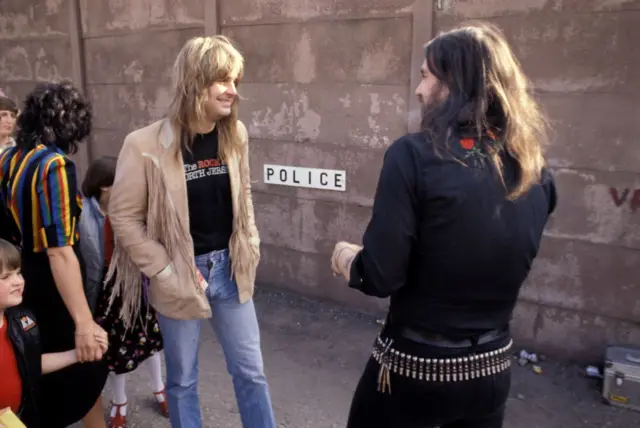 Ozzy Osbourne and Lemmy Kilmister share a private moment backstage in 1981
