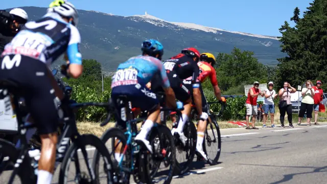 Riders on stage 16 of the 2025 Tour de France, with Mont Ventoux in the distance