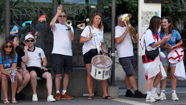 A group of England supporters play musical instruments to drum up some atmosphere