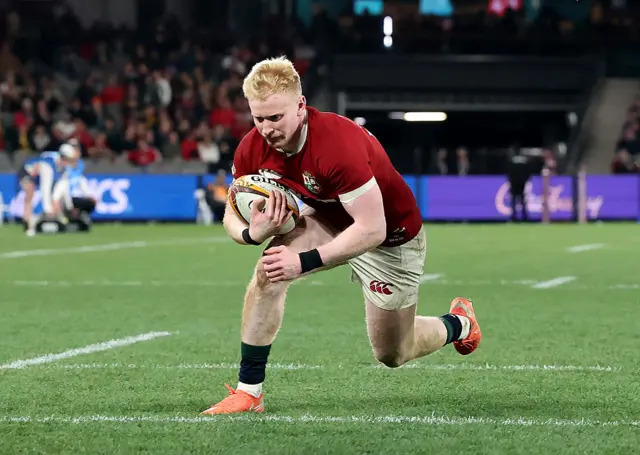 Jamie Osborne of the British & Irish Lions dives over for their third try