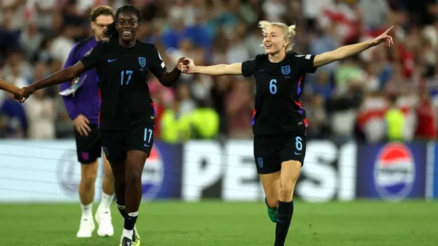 Michelle Agyemang and Leah Williamson of England celebrate after the teams victory and progression to the final following the UEFA Women's EURO 2025 Semi-Final match between England and Italy at Stade de Geneve