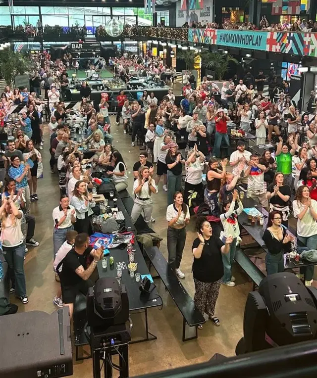 Fans stand to applaud Jess Carter in Boxpark, Wembley
