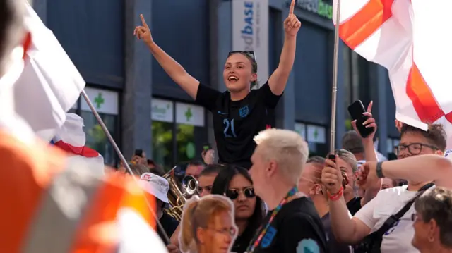 An England fan enjoys the pre-match atmosphere
