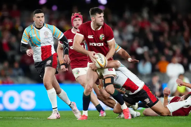 British and Irish Lions' Blair Kinghorn (centre) is tackled