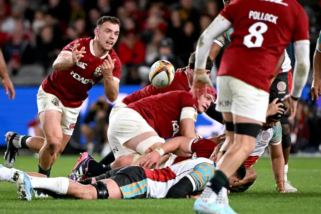 British and Irish Lions' Ben White (L) passes the ball