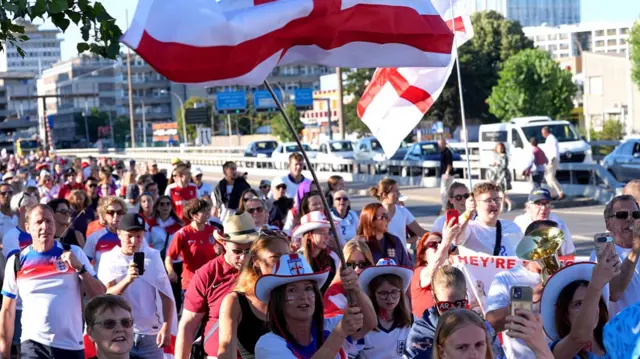 England fans take part in a fan walk to the stadium