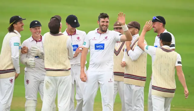 Somerset players all congratulate Craig Overton on taking a wicket