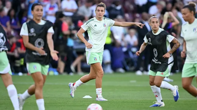 Italy's forward #10 Cristiana Girelli (C) gestures during the warm up ahead of the UEFA Women's Euro 2025 semi-final football match between England and Italy at the Stade de Geneve in Geneva