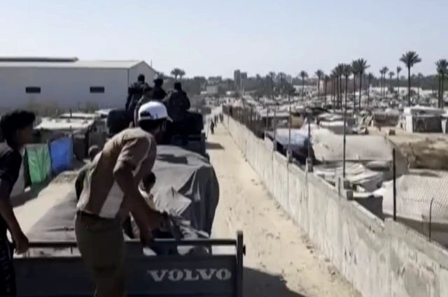 Screengrab from a video showing armed men escorting World Health Organisation (WHO) branded lorries containing "medicines and medical supplies" to a warehouse in Gaza.