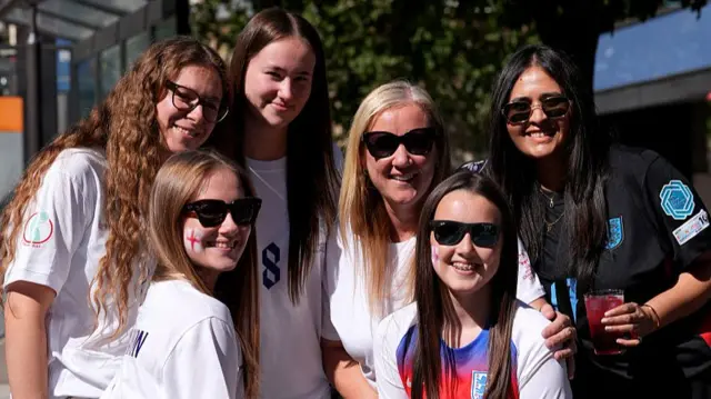 A group of female England supporters pose for a picture in the sun