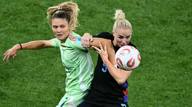 Italy's forward #21 Michela Cambiaghi (L) vies with England's defender #05 Alex Greenwood (R)