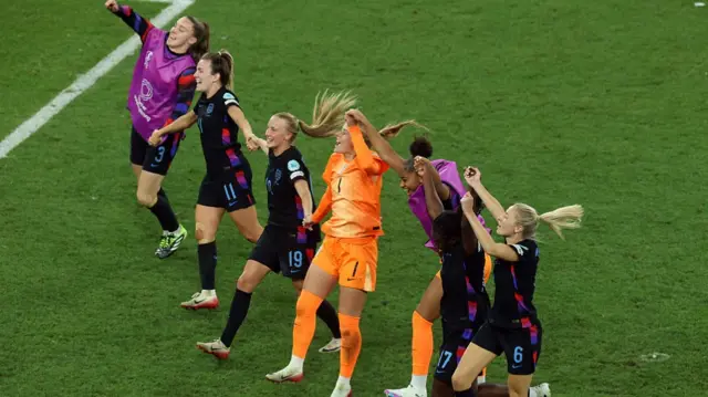 Players of England celebrate the teams victory and progression to the final