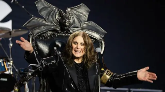 Ozzy sat on a chair on stage