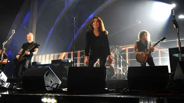 Ozzy Osbourne performs on stage with the members of Metallica.
