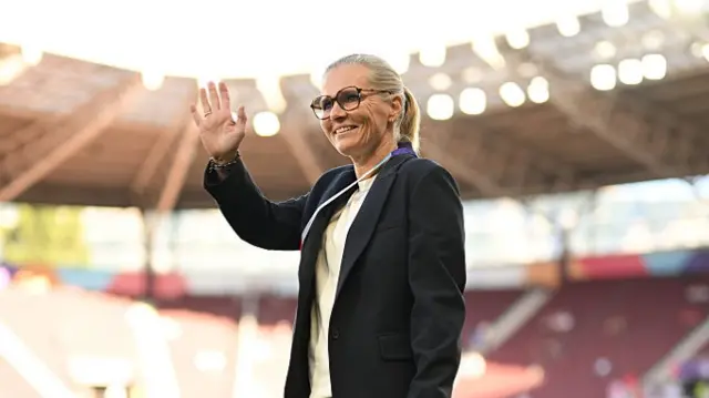 Sarina Wiegman, Head Coach of England, waves as she inspects the pitch