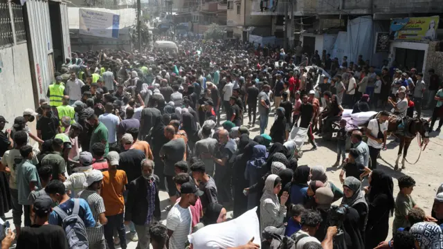 Palestinians gather to receive aid at a distribution centre in Gaza City.