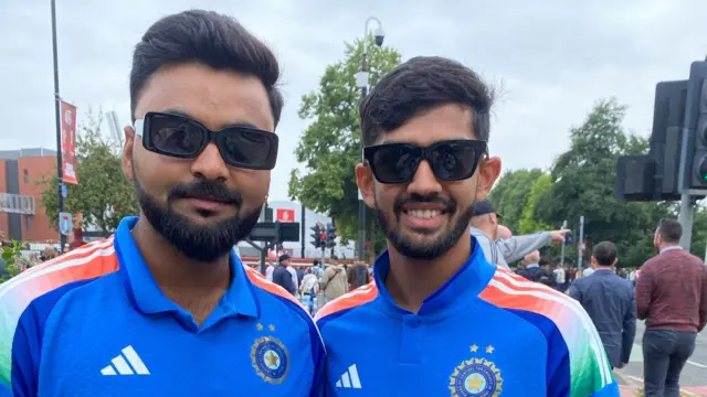 India fans Yosh and Jaimen, wearing India shirts while standing outside Old Trafford