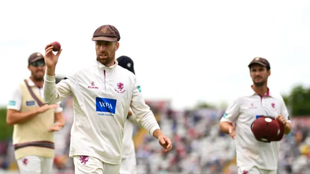 Jack Leach walks off, raising the ball in the air to acknowledge his six wickets