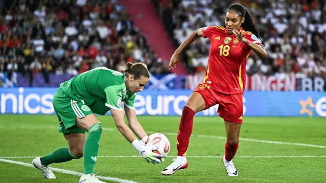 - Germany's goalkeeper #01 Ann-Katrin Berger (L) gathers the ball from the feet of Spain's forward #18 Salma Paralluelo (R)