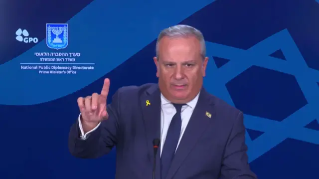 Israeli spokesman David Mencer gestures during a press briefing.