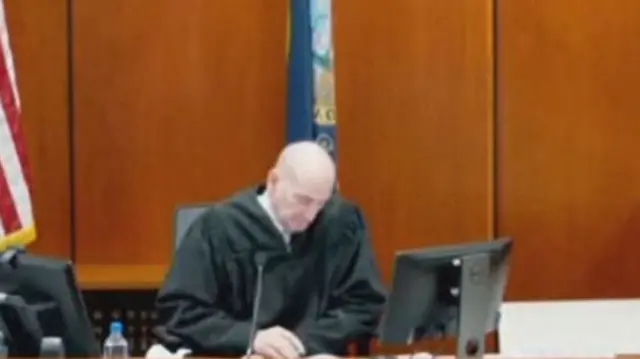 Judge sitting looking down