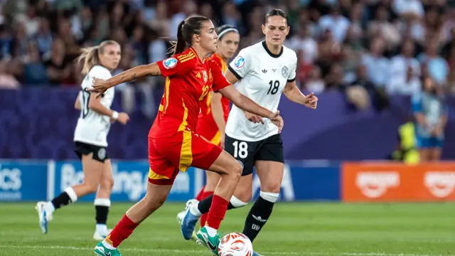 atri Guijarro of Spain (L) controls the ball under pressure from Giovanna Hoffmann of Germany (R)